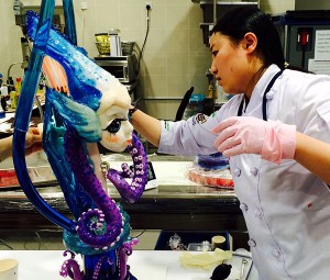 Student of Academy of Malaysia ellaborating sugar piece