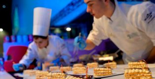 Young pastry chefs finishing their dessert creation