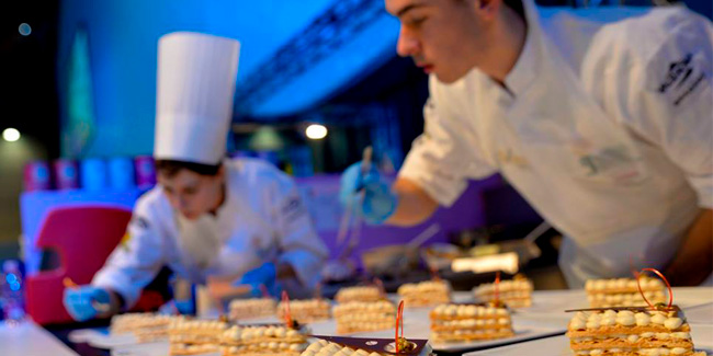 Young pastry chefs finishing their dessert creation