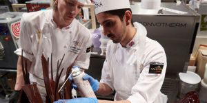 british team working on a chocolate sculpture