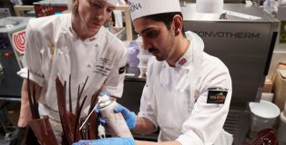 british team working on a chocolate sculpture