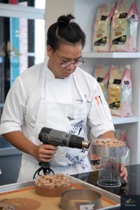 Student unmolding the cake